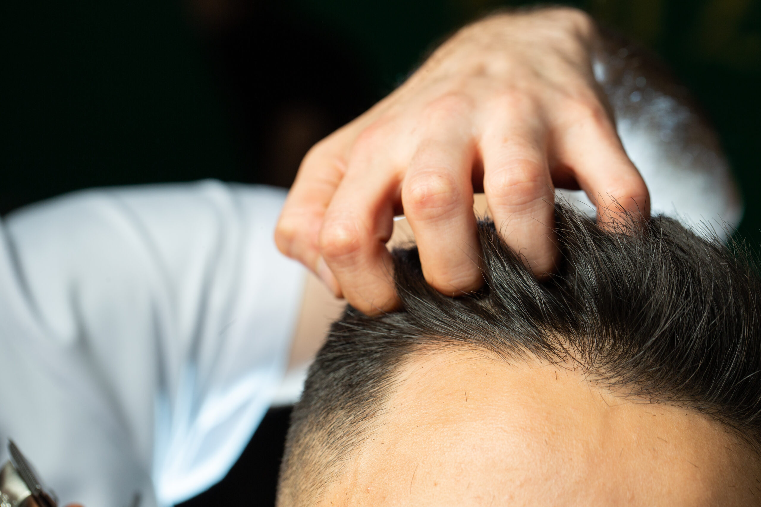 barber checks with fingers hairs