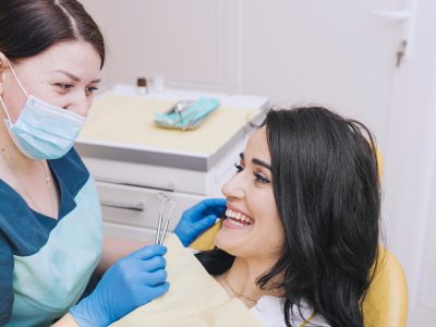 dentist-sitting-near-female-patient