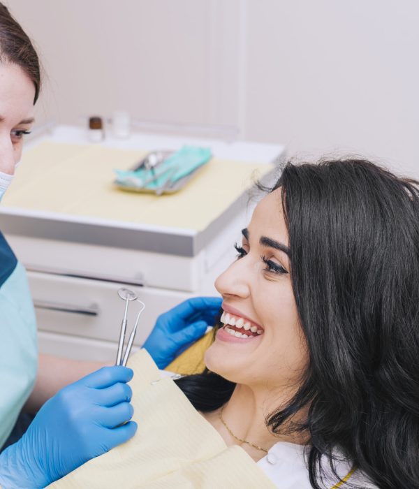 dentist-sitting-near-female-patient